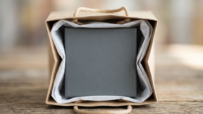 A small product perfectly fitted inside a compact paper bag with minimal extra space
